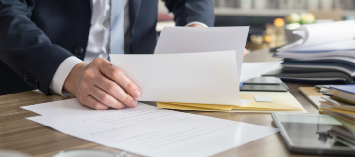 Finance professional reviewing overdue invoices and accounts receivable workflow for Commercial Debt Collection for Business Cash Flow